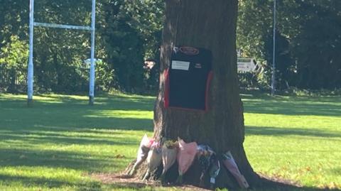 A floral tribute at a rugby pitch