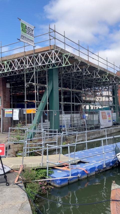A boatyard with alot of scaffolding around it. 