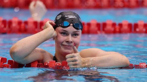 Scottish swimmer Katie Shanahan gives a thumbs-up from the pool.