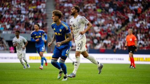 Matheus Cunha of Manchester United in action with Joe Rodon of Leeds