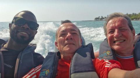 Yostin Mosquera (l) Albert Alfonso (M) and Paul Longworth (R). They are all on a speedboat smiling into camera.