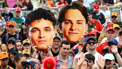 Fans hold up giant heads of Lando Norris and Oscar Piastri in Melbourne 