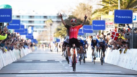 Filippo Ganna raises his arms in celebration after winning the first stage of the Volta ao Algarve - before the stage was cancelled