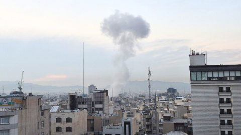  Smoke rises above buildings after explosions struck the northeastern, western, and central areas amid Israeli attacks in Tehran.