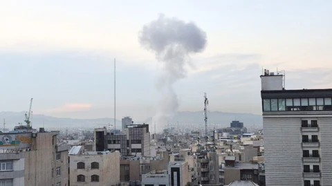  Smoke rises above buildings after explosions struck the northeastern, western, and central areas amid Israeli attacks in Tehran.