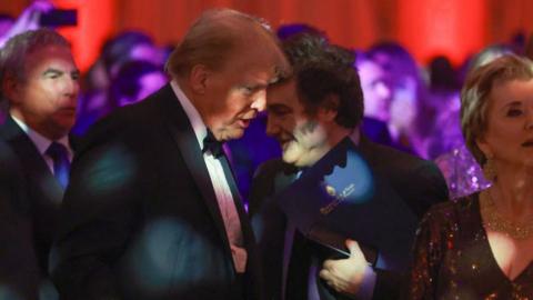 Argentine President Javier Milei walks past U.S. President-elect Donald Trump as they attend the America First Policy Institute Gala held at Mar-a-Lago on November 14, 2024 in Palm Beach, Florida