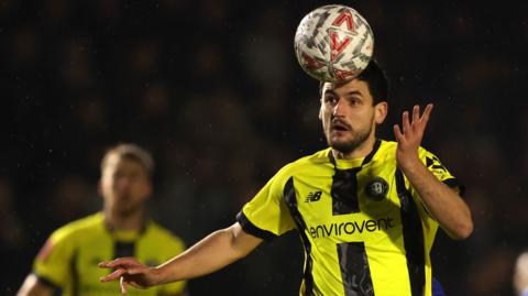 Harrogate Town's Anthony O'Connor heads the ball