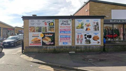 Advertising for Deli Plaza, featured on the wall of the kiosk in Thornbury, Bradford