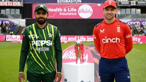 Pakistan captain Babar Azam (left) and England captain Jos Buttler (right) stand either side of the T20 series trophy