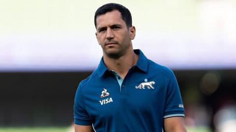 Argentina international Matías Moroni walks out on a pitch before a game.
