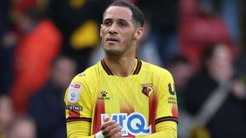 Tom Ince applauds the Watford fans at the end of a match in the team's yellow and red home shirt
