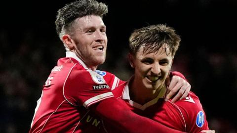 Wrexham's Josh Windass (left) celebrates with goal scorer Max Cleworth (right)