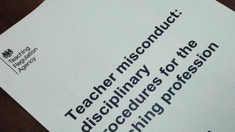 A white piece of paper with the Teaching Regulation Agency logo in the top left-hand corner. The words "Teacher misconduct: disciplinary procedures for the teaching profession" can be seen on the paper.