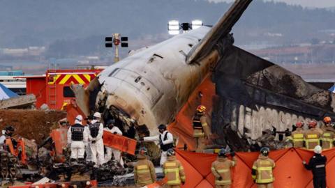 Fire authorities search for the missing and recover the deceased at the site of an accident near Muan International Airport in Jeollanam-do, South Korea, on December 29, 2024