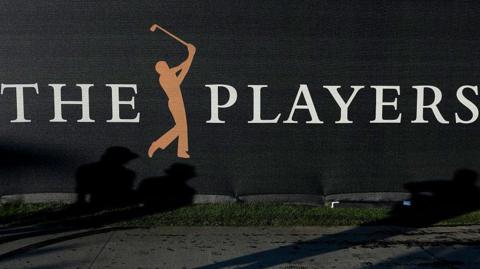 A sign at the Players Championship showing a silhouette of a person swinging a golf club between the words 'The' and 'Players'