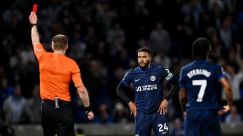 Reece James is shown a red card against Brighton