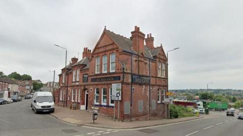 A Google street view image showing The Red Lion pub in Heanor at the junction of the A608 and Derby Road.