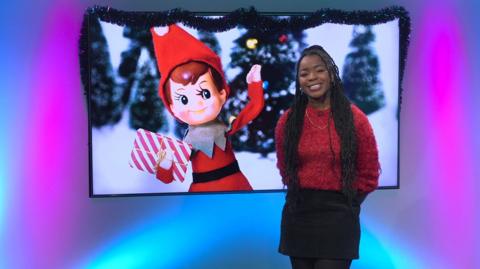 Emma-Louise in the studio with an elf in the screen