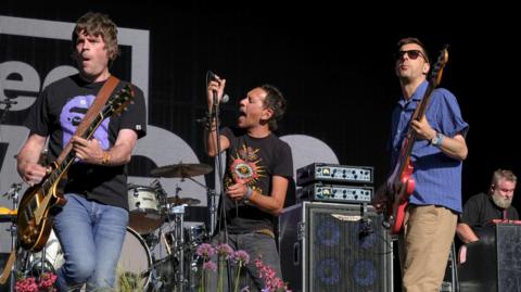 Paul Adrian Banks, Rick Witter and guitarist Tom Gladwin performing at Camp Bestival in Dorset in 2022