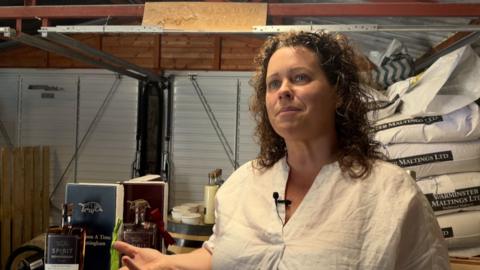 woman in white shirt and curly hair
