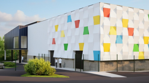 Artist's impression of the new sports and community centre in Preston. A white and multi-coloured wall is seen whilst a darker, adjoining building is behind.