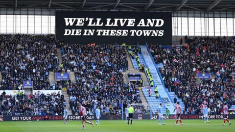 "We'll Live and Die in These Towns" displayed by a banner inside the CBS Arena, during Coventry's match against Sunderland.