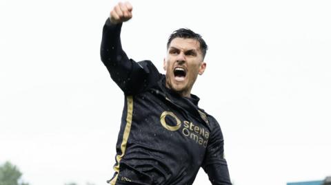 Hearts score late on