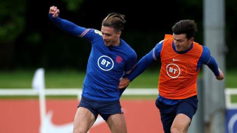 Jack Grealish and Harry Maguire in action during England training