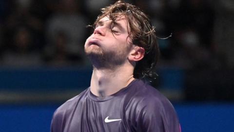 Jack Draper reacts after injuring himself at the Japan Open