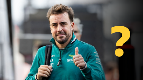 Fernando Alonso gives the thumbs-up gesture while wearing his Aston Martin uniform