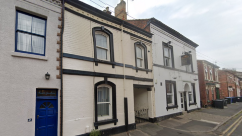 A shut pub building on a terraced street