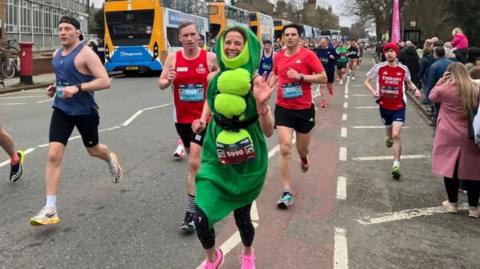 A woman in a pea pod costume