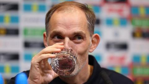 England head coach Thomas Tuchel sips a glass of water at a press conference after naming his first squad since succeeding Gareth Southgate