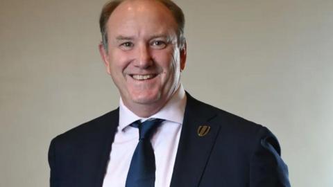 Brett Robinson wearing a World Rugby pin badge