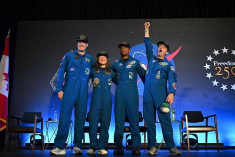 Jeremy Hansen, Christina Koch, Victor Glover and Reid Wiseman wave to the crowd the day after splashing down in the Pacific Ocean, at Ellington Field Joint Reserve Base in Houston, Texas, U.S. April 11, 2026.