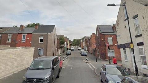 Hinde Street in Page Hall. A tightly packed terrace street with cars parked on either side of the road.