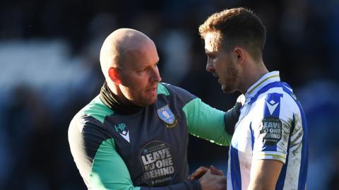 Henrik Pedersen consoles Sheffield Wednesday's Will Vaulks