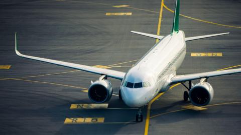 A commercial airplane during taxiing to an airport runway for take-off.