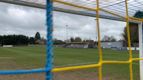 Northcourt Road has a small yellow and blue stand and two dugouts looking out over the pitch.