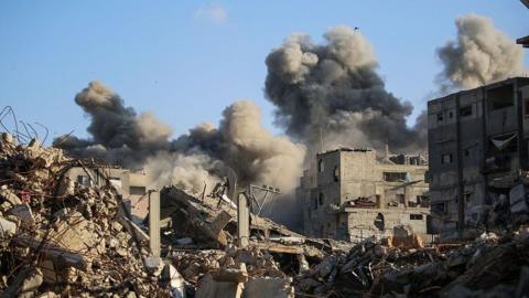 Smoke billows following an Israeli strike that targeted a building in the Bureij camp for Palestinian refugees in the central Gaza Strip on October 19, 2025. 