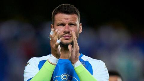 Daniel Bachmann applauding Deportivo La Coruna fans after a match.