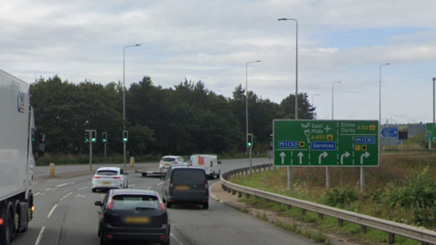 Part of the M1 junction roundabout with signs showing drivers the way to the airport