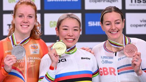 Katy Marchant shows off her bronze medal in the women's keirin alongside winner Mina Sato and the Netherlands' silver-medallist Hetty van de Wouw