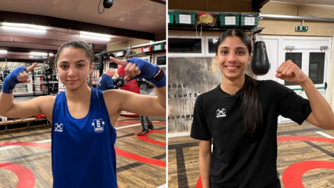 Jaya Kalsi is wearing a blue shirt and is seen in a boxing gym. She is also wearing blue supports on her wrists and is holding both hands aloft. Serena Mali is wearing a black T-shirt, has long hair tied back and is holding a fist in the air. 