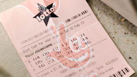 A stock image of a National Lottery lotto ticket on pink paper.