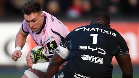 Cardiff flanker Taine Basham with ball in hand attacks Edouard Jabea Njocke
