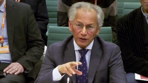 Samir Shah gestures as he speaks while looking towards the camera in the UK Parliament hearing on 24 November.