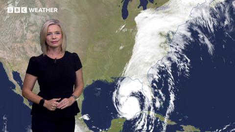 Sarah Keith-Lucas in front of a satellite image of Hurricane Helene