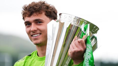 Celtic's Callum Osmand, who scored the third Celtic goal in the SPL title decider against Heart of Midlothian, poses with the SPL trophy during photocall at Lennoxtown Training Ground, Glasgow.