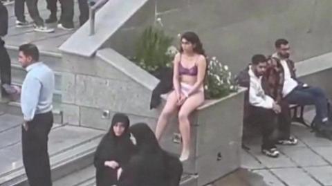 Screengrab of a video showing an Iranian woman sitting in her underwear at the Science and Research Branch of Islamic Azad University in Tehran, Iran